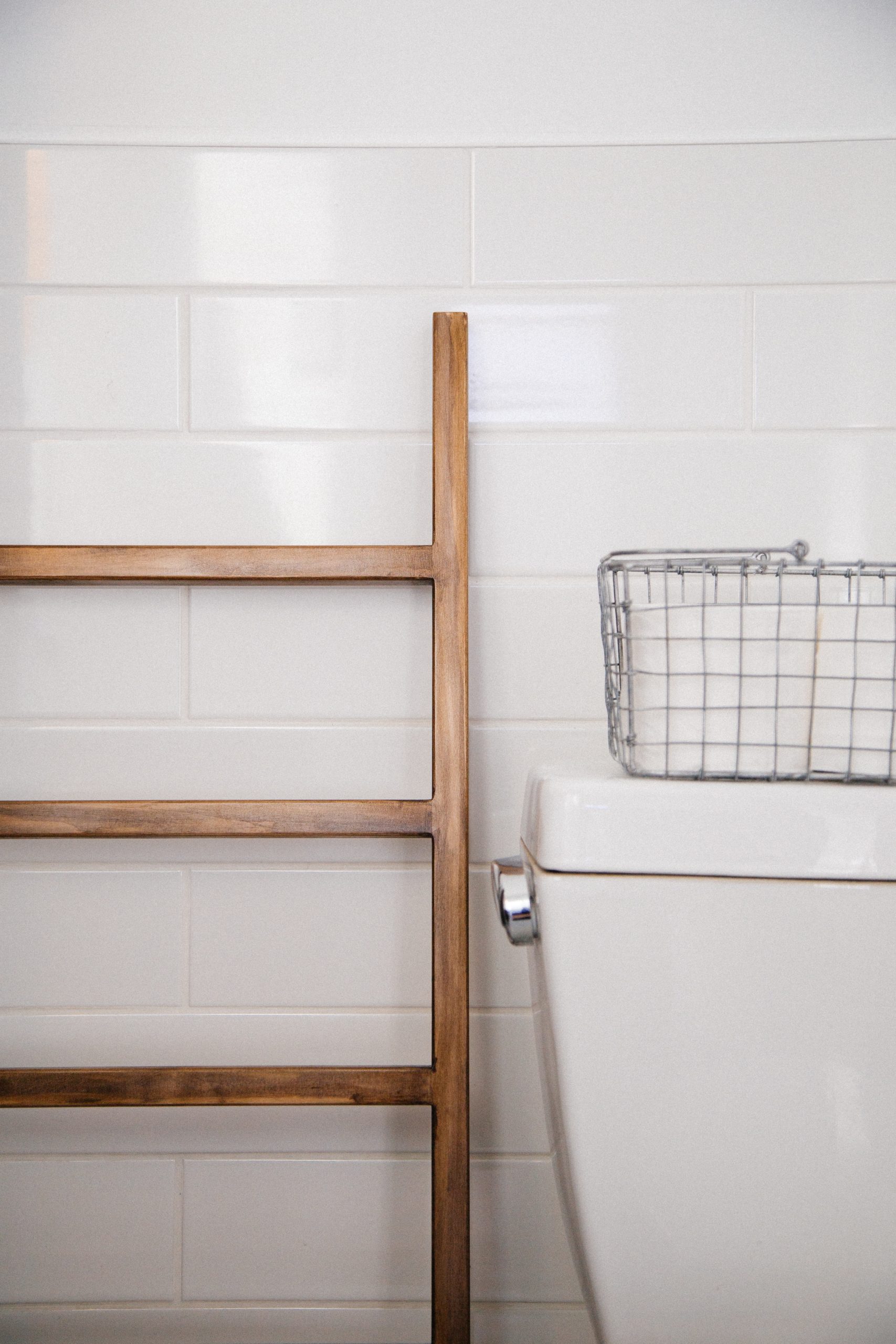 image of bathroom with empty wooden towel rack and white tile