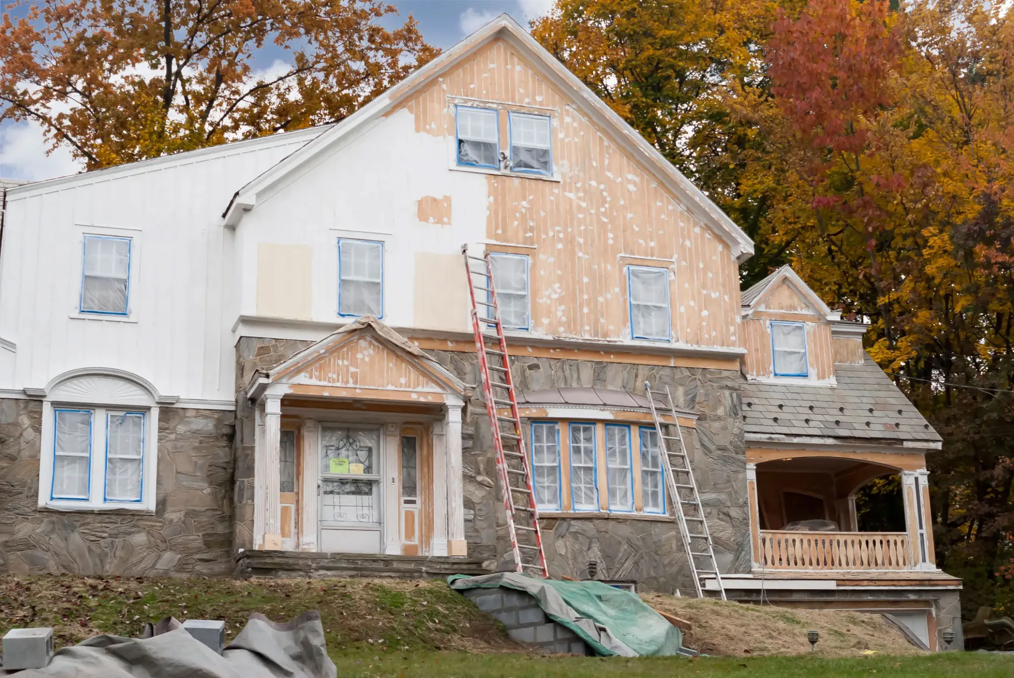 a cottage home under construction with warm tones and stone accents