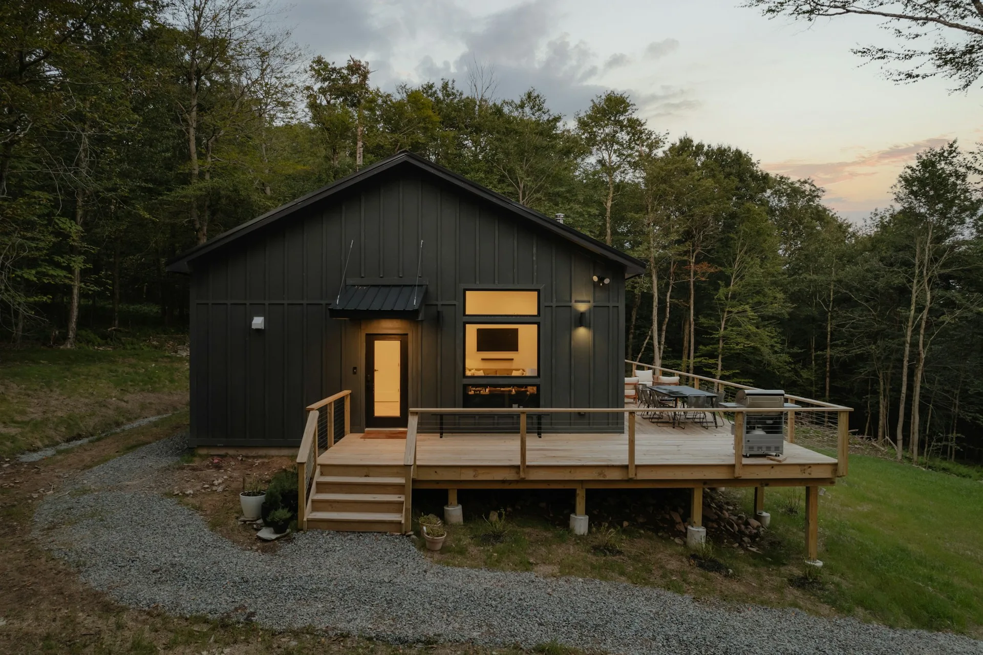 an image of a house with modern details. A simple entry doors, windows withougt grids and simple railings.
