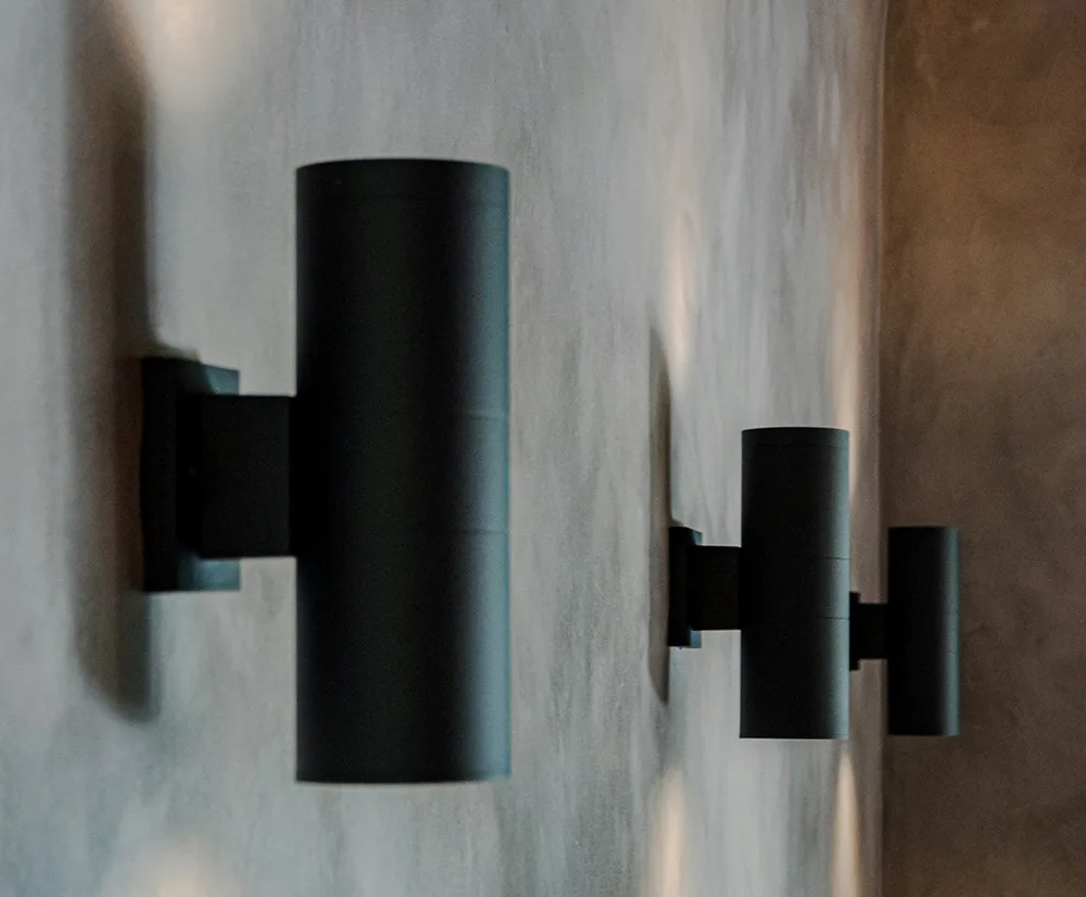 modern cylinder lights on a stucco wall